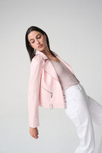 Load image into Gallery viewer, Woman wearing a light pink jacket over a sequin top and white pants and bending backwards against a white background.