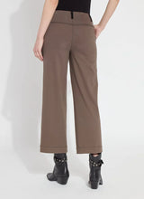 Load image into Gallery viewer, Our Franca Seamed Wide Leg Crop in 4-way stretch Knit Denim features a concealed patented waistband, tricot-lined pockets for a smooth silhouette, contrast-color topstitching, and vegan suede belt loops. Designed to fit snugly at the waist and skim the hips, it flares into a wide-legged crop. With a back yoke and garment dye for added softness, it includes vertical seams running from the pocket to the hem, enhancing the appearance of slimmer hips.