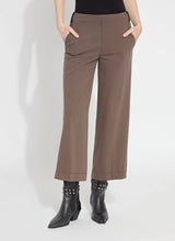 Load image into Gallery viewer, Our Franca Seamed Wide Leg Crop in 4-way stretch Knit Denim features a concealed patented waistband, tricot-lined pockets for a smooth silhouette, contrast-color topstitching, and vegan suede belt loops. Designed to fit snugly at the waist and skim the hips, it flares into a wide-legged crop. With a back yoke and garment dye for added softness, it includes vertical seams running from the pocket to the hem, enhancing the appearance of slimmer hips.