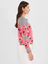 Load image into Gallery viewer, Woman wearing a stripe and floral patterned cardigan and white pants against a white background.