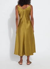 Load image into Gallery viewer, The Lyssé Gemma Silk Slip Dress is a luxurious and elegant piece designed for effortless sophistication. Crafted from high-quality polyester, this slip dress offers a smooth, lightweight, satin feel that drapes beautifully on the body. The Manzanilla color adds a rich, warm tone, making it perfect for both casual and formal occasions.