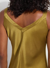 Load image into Gallery viewer, The Lyssé Gemma Silk Slip Dress is a luxurious and elegant piece designed for effortless sophistication. Crafted from high-quality polyester, this slip dress offers a smooth, lightweight, satin feel that drapes beautifully on the body. The Manzanilla color adds a rich, warm tone, making it perfect for both casual and formal occasions.