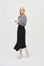 Load image into Gallery viewer, Crafted from exquisite georgette material, this black and white plaid top with dots of color, exudes elegance and sophistication, making it the perfect addition to any outfit. The V-neckline is adorned with a charming scarf tied at the center, adding a touch of refinement to this modern piece. The long puff sleeves with cuffs add a playful touch, while exuding confidence in this delightful top.