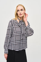 Load image into Gallery viewer, Crafted from exquisite georgette material, this black and white plaid top with dots of color, exudes elegance and sophistication, making it the perfect addition to any outfit. The V-neckline is adorned with a charming scarf tied at the center, adding a touch of refinement to this modern piece. The long puff sleeves with cuffs add a playful touch, while exuding confidence in this delightful top.