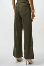 Load image into Gallery viewer, Woman wearing avocado green top, avocado green denim pants and off-white heels against a white background.