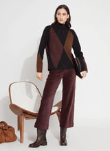 Load image into Gallery viewer, The distinctive Greta Pullover Sweater, made from soft Knit Jacquard, features a sleek funnel neck, shimmering Copper Lurex highlights, side slits with Vegan Suede detailing, and a sophisticated high-low hem. It pairs perfectly with brown or black bottoms for a timeless style, or with denim for a casual vibe.