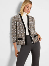 Load image into Gallery viewer, Woman wearing a black multicolored cardigan over a white turtleneck and grey pants against a white background.
