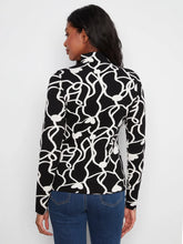 Load image into Gallery viewer, A woman shown from the back wearing a black long-sleeve mock-neck top with a white abstract wavy line pattern, paired with blue jeans, against a plain white background.