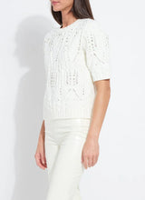 Load image into Gallery viewer, Woman wearing a white knit sweater with rhinestones and white pants against a plain background.