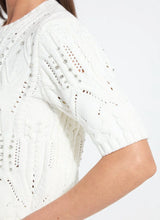 Load image into Gallery viewer, Close-up of a white sweater top with rhinestones against a white background.