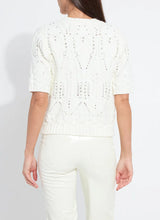 Load image into Gallery viewer, Woman wearing a white knit sweater with rhinestones and white pants against a plain background.
