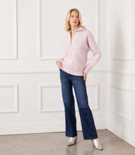 Load image into Gallery viewer, Woman wearing a zip front pink sweater, blue jeans and silver boots against a white wall.