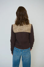 Load image into Gallery viewer, Woman wearing a brown sweater knit and tweed jacket and blue jeans against a white background.