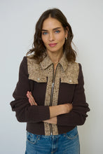 Load image into Gallery viewer, Woman wearing a brown sweater knit and tweed jacket and blue jeans against a white background.