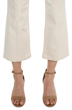 Load image into Gallery viewer, Close-up of tan denim flare hems and brown sandals against a white background.