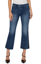 Load image into Gallery viewer, Our Hannah Crop Flare combines vintage inspiration with contemporary detailing, boasting a velvet trim for a modernized look. The cut hem of the medium washed denim elongates the silhouette while elevating the style. Make a statement and match it with the coordinating Denim Jacket for a complete ensemble. Color- Gilmore; dark blue with fading. 27” Inseam. Mid-rise. Velvet trim down the leg. Set-in waistband with belt loops. 5-Pocket styling details. Zip-fly and single logo button closure.