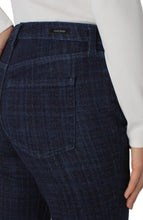 Load image into Gallery viewer, Close-up of dark blue plaid denim pants with a brand label against a white background.