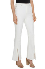 Load image into Gallery viewer, One of our favorite jeans this season, designed with vintage-like characteristics to give a rigid look while keeping comfort in mind. A high waisted silhouette, slim fit and flared leg offers a sleek and elongating look. A flattering twisted side slit at the hem take this jean to a new level! Dress it up with a beautiful blouse and heels or down with a classic tee and sneakers. 