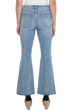Load image into Gallery viewer, One of our favorite jeans this season, designed with vintage-like characteristics to give a rigid look while keeping comfort in mind. A high-waisted silhouette, slim fit and flared leg offer a sleek and elongating look. A twisted side slit at the hem take this jean to a new level! Dress it up with a blazer and heels or dress down with a classic tee and sneakers. 