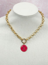 Load image into Gallery viewer, This vibrant and striking vintage Louis Vuitton Zipper Pull necklace is sure to catch everyone's eye. It's a stunning and distinctive piece, with a hot pink hue that gleams against the glossy gold chain.