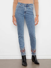 Load image into Gallery viewer, Model wearing a brown knit top, blue jeans with embroidered hem and black boots against a grey background.