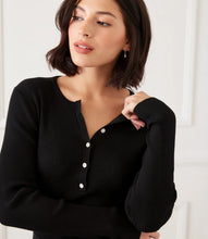 Load image into Gallery viewer, Woman wearing a black ribbed sweater with rhinestone buttons against a white background.