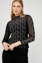Load image into Gallery viewer, Woman wearing a black long-sleeve top with geometric pattern and black pants against a white background.