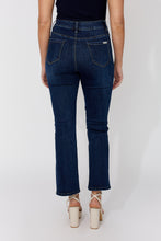 Load image into Gallery viewer, Model wearing dark blue jeans with decorative crystal buttons and beige sandals on a white background.