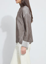 Load image into Gallery viewer, Person wearing a striped sweater and white pants against a plain background.