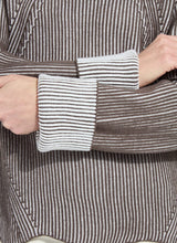 Load image into Gallery viewer, Close-up of a person wearing a brown and white striped shirt with a focus on the sleeve.