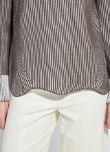 Load image into Gallery viewer, Close-up of a person wearing a brown and white sweater and white pants against a neutral background.