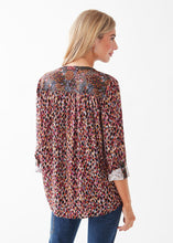 Load image into Gallery viewer, This long-sleeve top offers a unique mixed print design, creating an eye-catching aesthetic. Its versatile style allows for the sleeves to be worn both up or down, with a tab detail for a more relaxed look. Colors- Indi Abstract; Black, burgundy, light blue, white, orange, lilac. Button down. Roll Up Tab Sleeve. Mixed print. No stretch fabrication. Smocking detail on back.