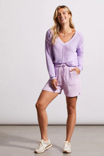 Load image into Gallery viewer, One of our top sellers, this light and adaptable V-neck sweater is a perfect choice for casual, trendy fashion. Our gorgeous sweater offers a stunning light purple color, pop-over design and long sleeves with drop shoulders, an exposed center seam, and a high-low hem with side-slit details. Color - Iris. Pop-over v-neck. Long sleeve with drop shoulder Exposed center seam; high-low hem with side slits Special reverse bleach print Fabric - 100% Cotton.