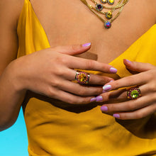 Load image into Gallery viewer, Make a real statement with the Jacci Ring! This bold, adjustable ring is made from light gold-plated brass base metal and is covered with twinkling high-quality crystals. The 12mm stone adds an extra touch of glamour and sparkle. Whether you're dressing up for a night out or adding a bit of bling for a special occasion, this Made in Canada piece will make you shine. Color- Gold, Fuchsia and mint green. High quality crystals. Gold plating over brass. One size, adjustable.
