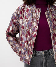 Load image into Gallery viewer, Model wearing a mosaic patterned jacket over a maroon turtleneck and grey jeans against a white background.