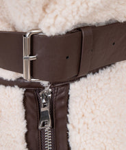 Load image into Gallery viewer, The luxurious Faux Fur Aviator Jacket in creamy ivory is a fashion statement. It boasts a plush faux fur exterior, complemented by dark brown leather accents and an elegant buckle detail for extra style. The inside is made of velvety suede that adds extra warmth. Designed with long sleeves and a zip-up closure, it's not only chic but also practical, ensuring warmth and fashion throughout the cooler seasons.