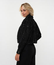 Load image into Gallery viewer, Woman wearing a black sequin jacket, black pants and silver hoop earrings against a white background.