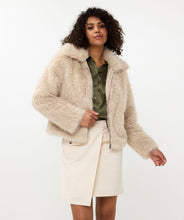 Load image into Gallery viewer, The Short Hairy Jacket is a stylish and warm garment. It boasts a plush faux fur exterior, a zip-up front, and a boxy, cropped silhouette. Crafted from 100% polyester, the jacket is soft to the touch and cozy, ideal for elevating your autumn and winter wardrobe. Combine it with a beloved blouse, skirt, and boots for an effortlessly fashionable ensemble.