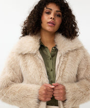 Load image into Gallery viewer, The Short Hairy Jacket is a stylish and warm garment. It boasts a plush faux fur exterior, a zip-up front, and a boxy, cropped silhouette. Crafted from 100% polyester, the jacket is soft to the touch and cozy, ideal for elevating your autumn and winter wardrobe. Combine it with a beloved blouse, skirt, and boots for an effortlessly fashionable ensemble.