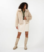 Load image into Gallery viewer, The Short Hairy Jacket is a stylish and warm garment. It boasts a plush faux fur exterior, a zip-up front, and a boxy, cropped silhouette. Crafted from 100% polyester, the jacket is soft to the touch and cozy, ideal for elevating your autumn and winter wardrobe. Combine it with a beloved blouse, skirt, and boots for an effortlessly fashionable ensemble.