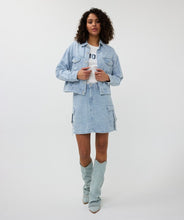 Load image into Gallery viewer, The Druna Distressed Jean Jacket by EsQualo features a light blue color and distressed denim quality. It is equipped with front pockets and adorned with rhinestone-encrusted buttons, giving it a touch of elegance. The texture almost resembles a boucle fabric.