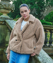 Load image into Gallery viewer, Wrap yourself in a stylish jacket that feels like a teddy bear hug. Our Teddy jacket is a stylish and cozy oversized piece. It boasts four buttons and trendy stitching details on the trim. Not only is this jacket fashionable, but it's also warm, making it an ideal choice for your autumn collection.