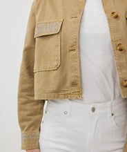 Load image into Gallery viewer, Add an edgy yet versatile piece to your wardrobe with the Wana Wide Studs Jean Jacket by EsQualo. This classic denim jacket is elevated with stylish studded details, making it a perfect choice for casual and trendy looks. Designed for comfort and durability, it pairs effortlessly with jeans, skirts, or dresses to create the ultimate chic ensemble. Ideal for layering during any season, this jacket is a must-have for those who love timeless fashion with a contemporary twist.