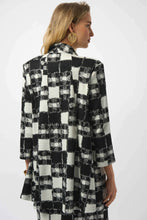 Load image into Gallery viewer, Woman wearing a black and white checkered blazer and matching skirt against a white background.