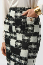 Load image into Gallery viewer, Woman modeling a white blouse and black and white plaid skirt and gold bracelet against a white background.
