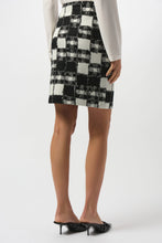 Load image into Gallery viewer, Woman modeling a white blouse and black and white plaid skirt and black heels against a white background.