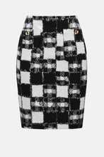 Load image into Gallery viewer, White and black plaid skirt against a white background.