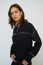 Load image into Gallery viewer, Woman wearing a black jacket with silver stud embellishments against a white background.
