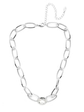 Load image into Gallery viewer, Elevate your jewelry collection with the Karisma Tennis Necklace, a statement piece designed to captivate. Featuring open metallic links that create an airy, lightweight feel, this necklace ensures effortless elegance. At its center, a dazzling crystal steals the spotlight, catching and reflecting light for a brilliant, eye-catching shimmer.