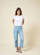 Load image into Gallery viewer, The Lyssé Katarina Eyelet Sleeve Trim Top is a refined yet effortless short-sleeve blouse featuring delicate eyelet-trimmed sleeves for a touch of elegance. Designed with a relaxed silhouette, this top offers both comfort and sophistication, making it a versatile addition to any wardrobe.